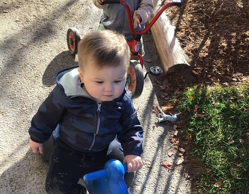 An infant riding on a riding toy