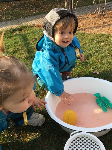 Children exploring a container of water