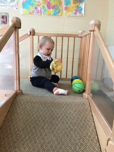 Infant playing with balls