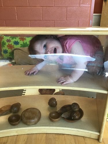 A child hiding on a shelf