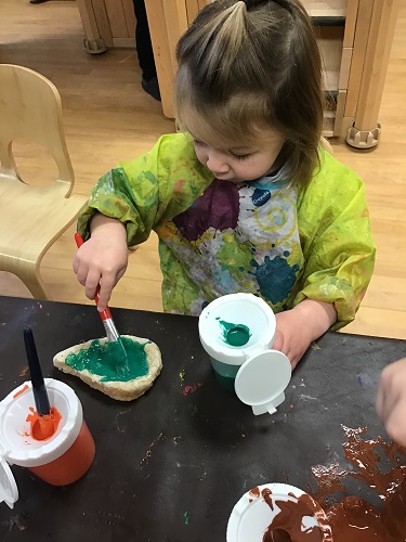 A child painting her Diva lamp