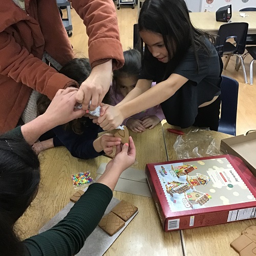 Children building a gingerbread house