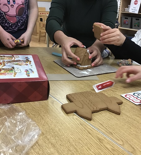 Children building a gingerbread house