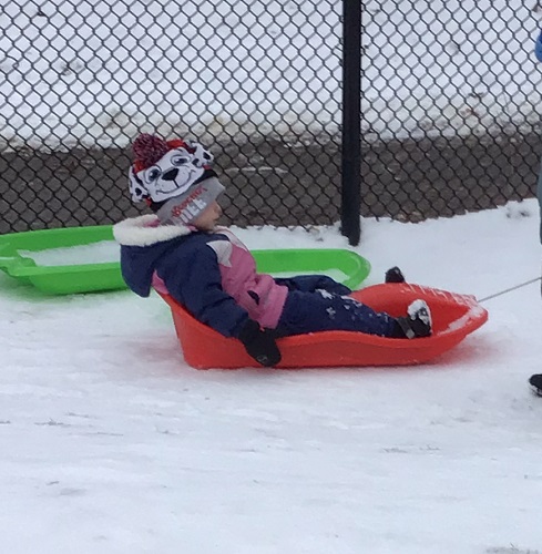 A child being pulled in a sled