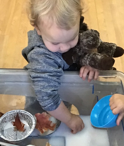 A toddler exploring the fall soup
